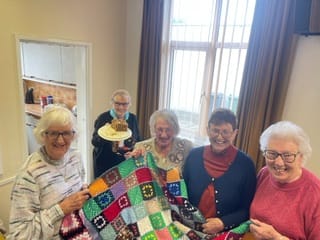 Milton Knitters Spread Warmth Worldwide