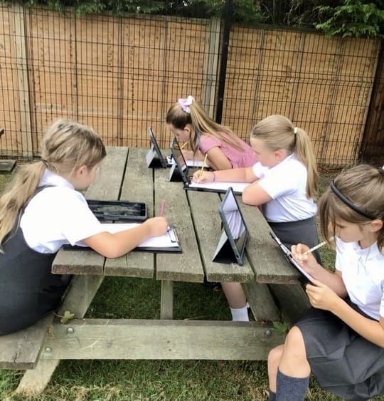 Pupils learn English outside under trees in their spectacular countryside school