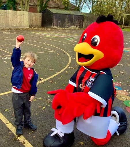 Pupils get to meet Thunder the Robin mascot while quizzing local footballer